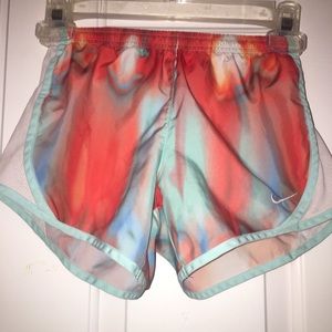blue,orange,pink,and red nike shorts.